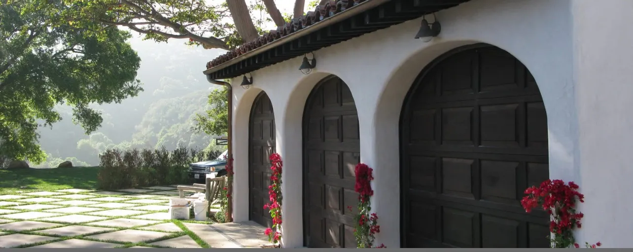 Mediterranean home with three garage doors